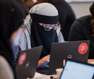 Close up of seated students working on computers.